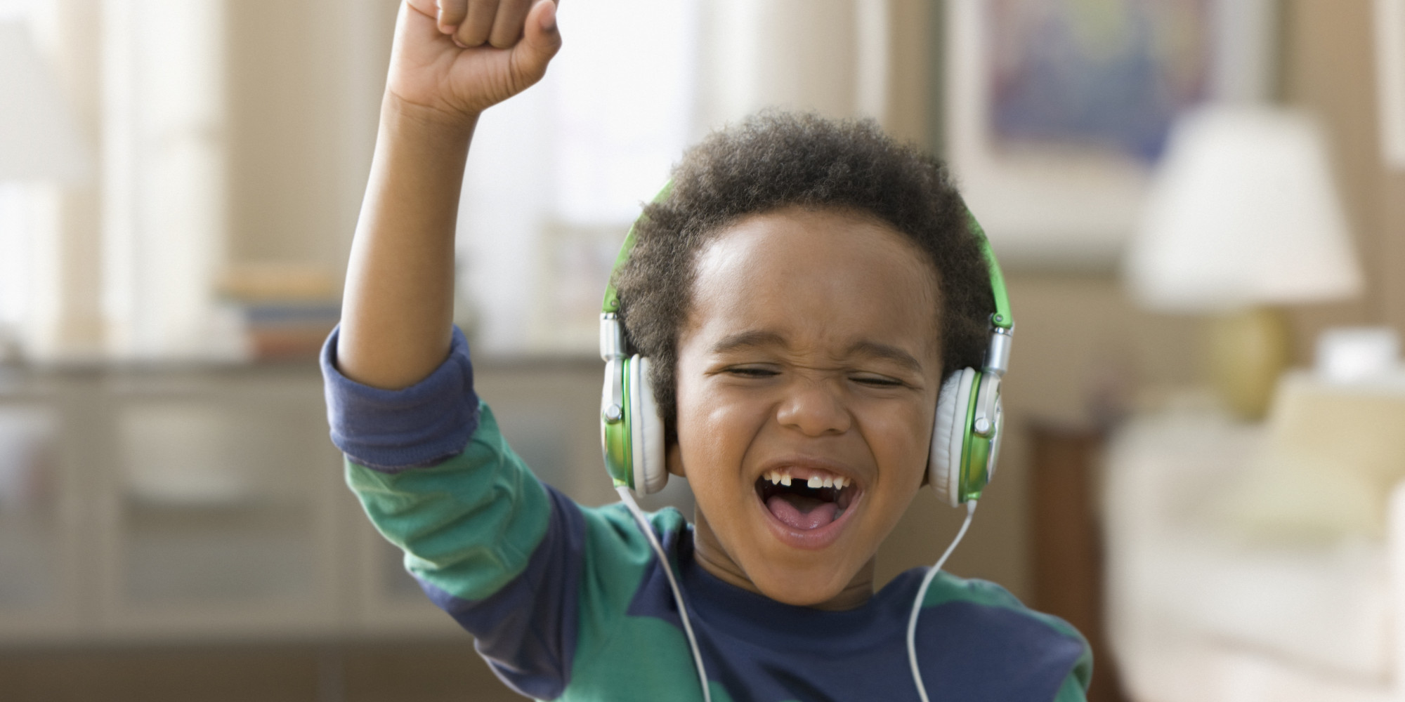Black boy listening to music on headphones