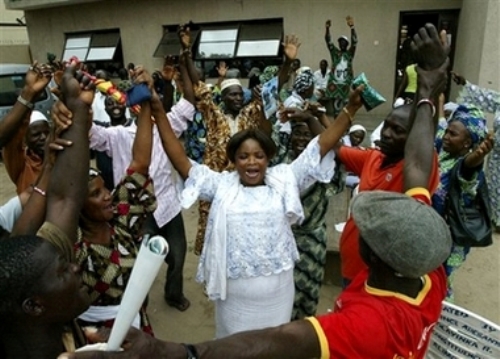 Supporters of Umaru Yar'Adua celebrate outside the Lagos headquarters of the People's Democratic Party in Lagos, Nigeria, Monday, April 23, 2007. Yar'Adua, the governing party candidate, was declared the winner Monday after Nigeria's weekend presidential elections that were denounced by the opposition and declared deeply flawed by international observers. (AP Photo/Sunday Alamba)