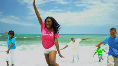 stock-footage-african-american-family-spending-summer-holiday-together-on-beach