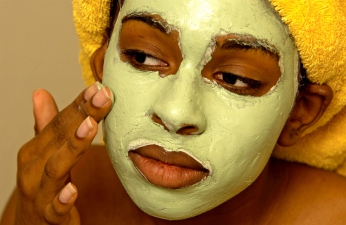 Woman putting on a facial mask